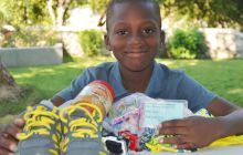 boy with gifts from his sponsor