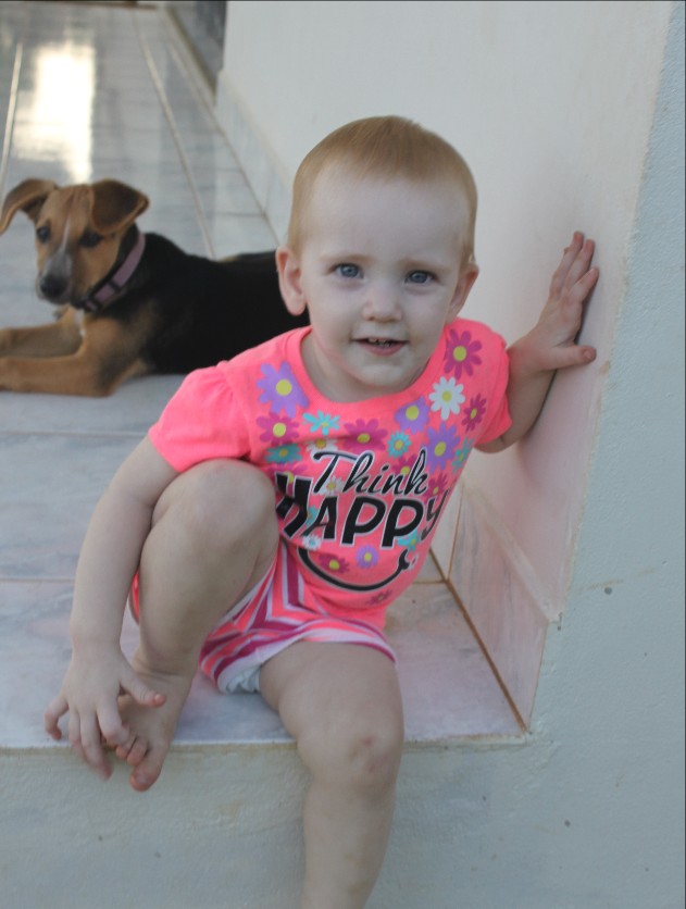 Kay-Marie Thompson sitting on the Bennetts porch with neighbor-dog Xena