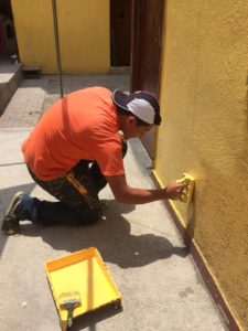 Abraham Ortuno helps out with a painting project at the Zone 10:14 Community Center in Mexico City.